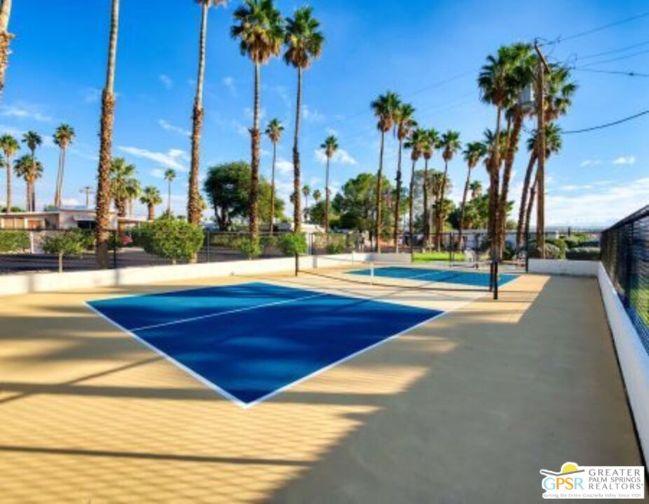18131 Langlois Road, Unit H1 Desert Hot Springs, CA 92241 - Photo 42 of 44 a view of a swimming pool with palm trees
