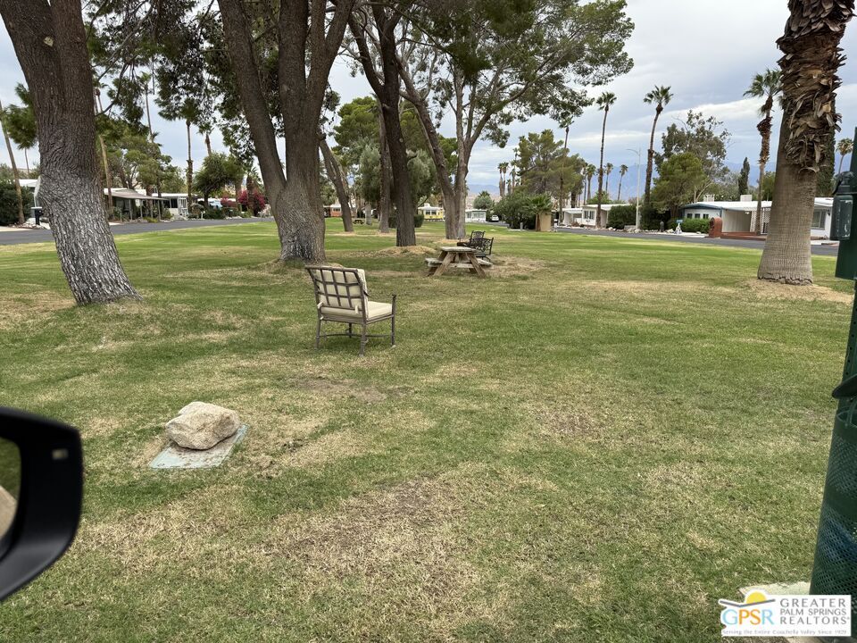 18131 Langlois Road, Unit H1 Desert Hot Springs, CA 92241 - Photo 44 of 44 a backyard of a house with table and chairs