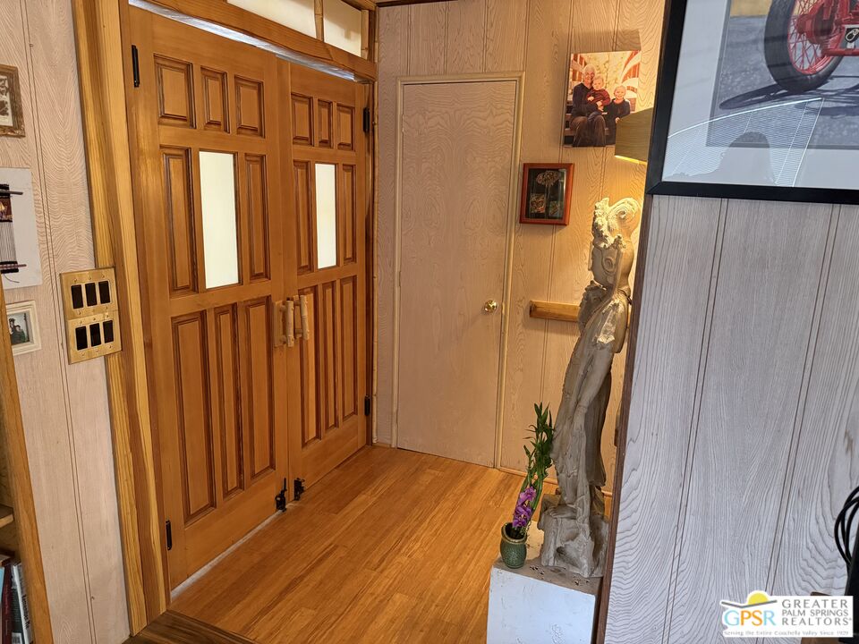 18131 Langlois Road, Unit H1 Desert Hot Springs, CA 92241 - Photo 5 of 44 a view of a closet with wooden floor and stairs