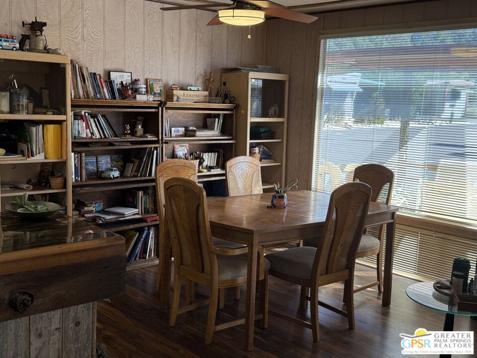 18131 Langlois Road, Unit H1 Desert Hot Springs, CA 92241 - Photo 9 of 44 a dining room with furniture and wooden floor