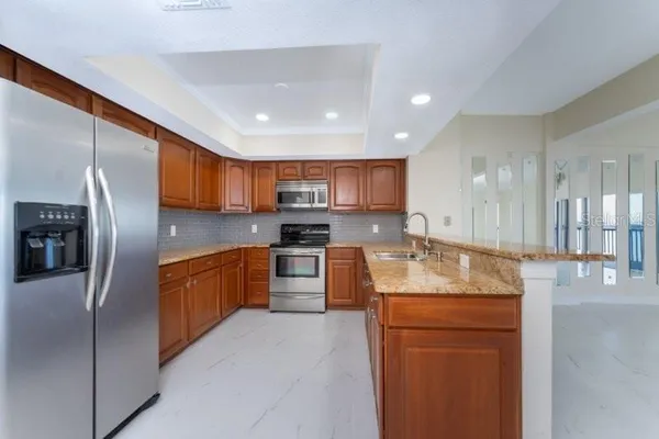 a large kitchen with stainless steel appliances lots of counter top space