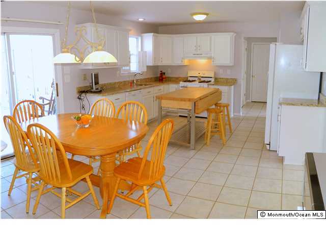 344 Fieldcrest Drive New Egypt, NJ 08533 - Photo 3 of 17 a open kitchen with stainless steel appliances kitchen island granite countertop a table chairs and a refrigerator