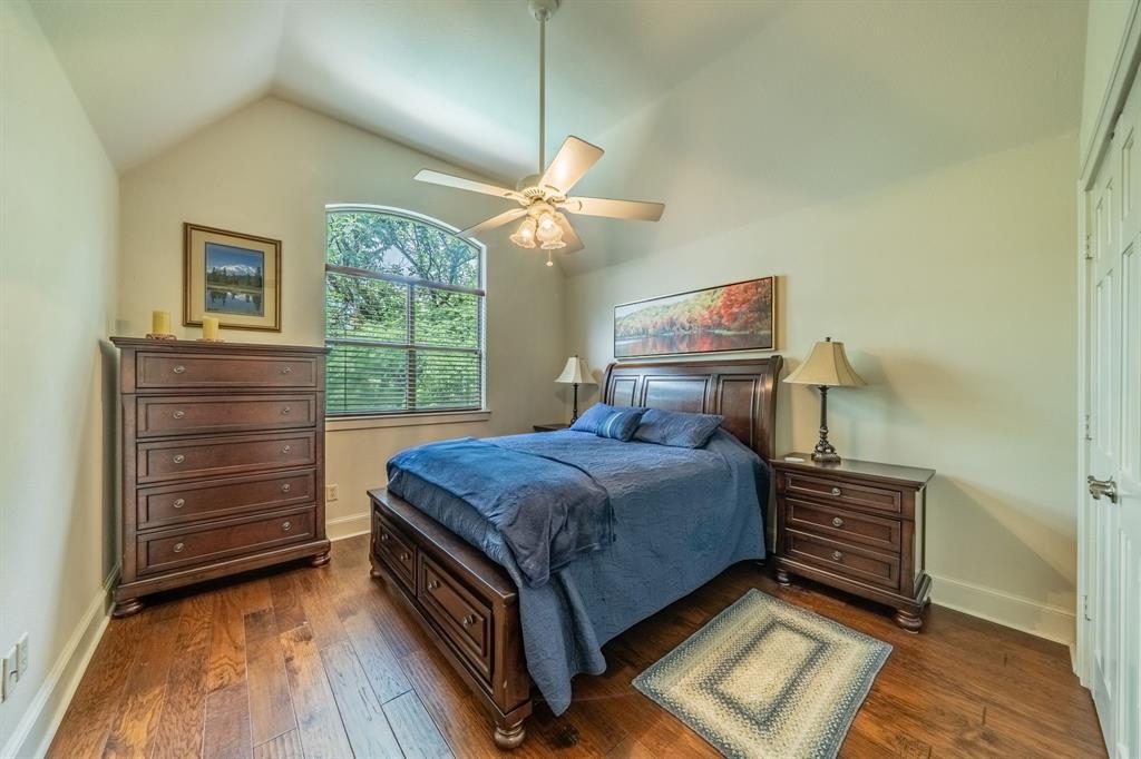 7451 County Road 1509 Athens, TX 75751 - Photo 17 of 36 a bedroom with a bed and a chandelier