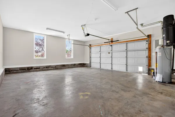 an empty room with a window and a ceiling fan