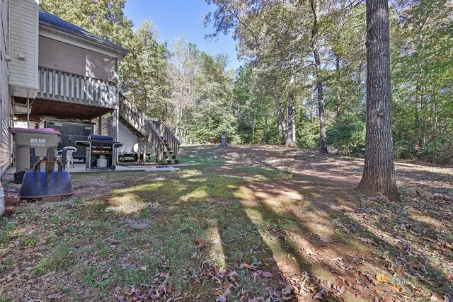a view of a house with yard and a tree