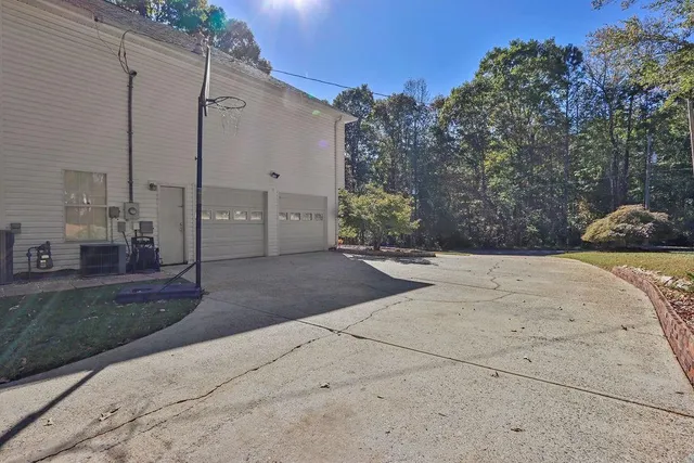 a front view of a house with a yard and trees
