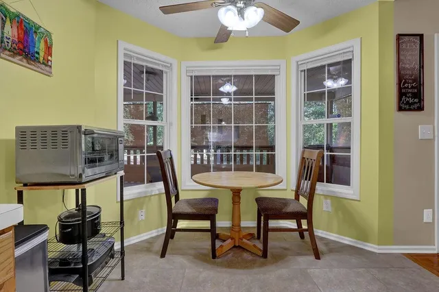 a view of a dining room with furniture and chandelier
