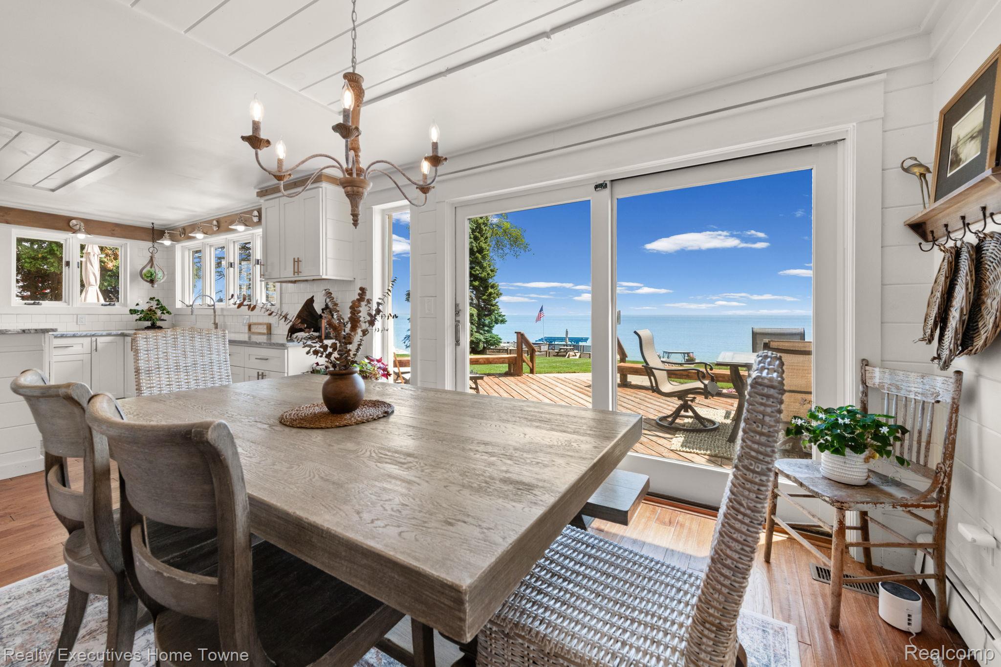 8308 Lakeshore Road Fort Gratiot, MI 48059 - Photo 49 of 79 Dining area featuring sliding glass doors opening to an expansive deck with water scenery