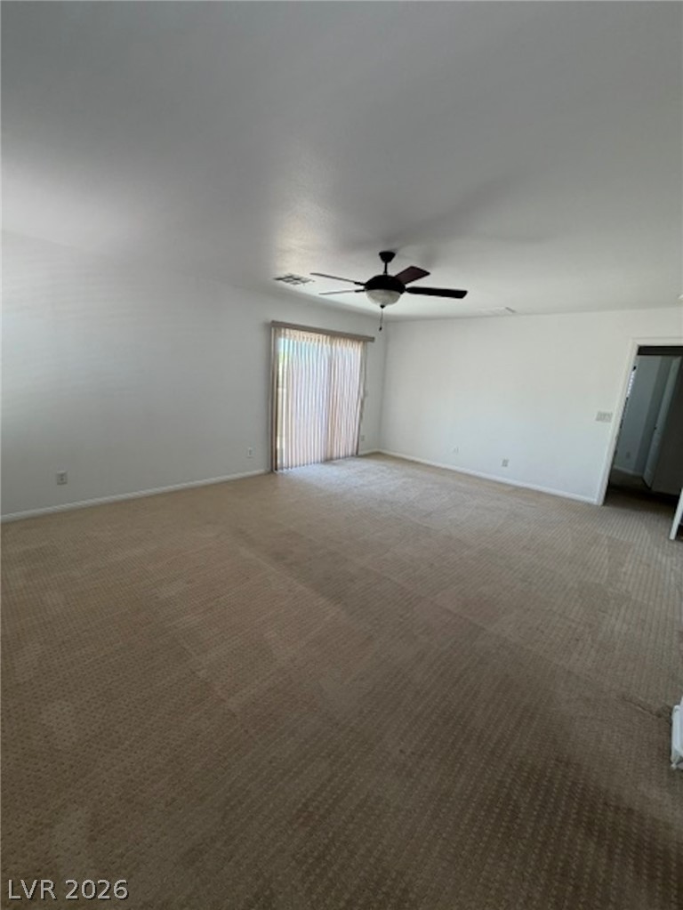 3862 Landing Ridge Place Las Vegas, NV 89135 - Photo 11 of 26 A spacious room offers comfortable carpeting and convenient sliding door access to outdoor areas.