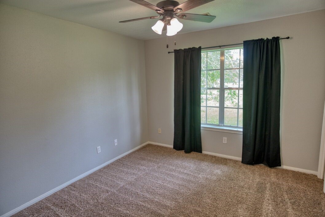 308 County Road 893B Angleton, TX 77515 - Photo 22 of 41 wooden floor in an empty room with a window