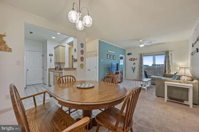 a view of a dining room with furniture and a chandelier