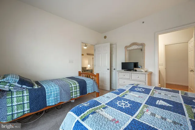 a bedroom with two beds and a television