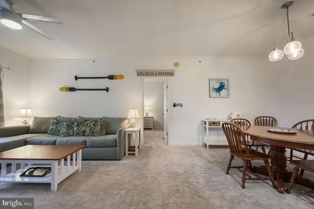 a living room with furniture a air conditioner vent and a window