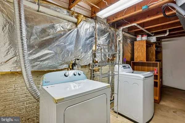 an empty room with an entryway and fan