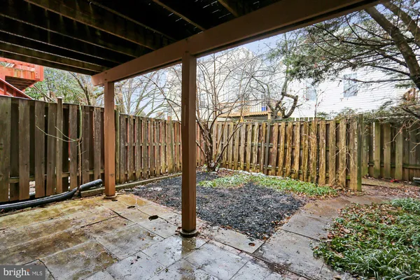 a view of a backyard with wooden fence