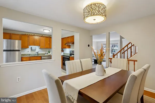 a view of a dining room with furniture and a potted plant