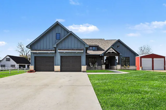 a front view of house with yard and green space