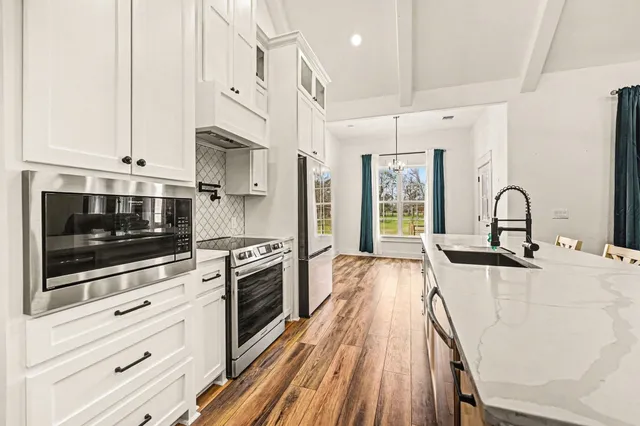a kitchen with stainless steel appliances granite countertop a stove and a sink