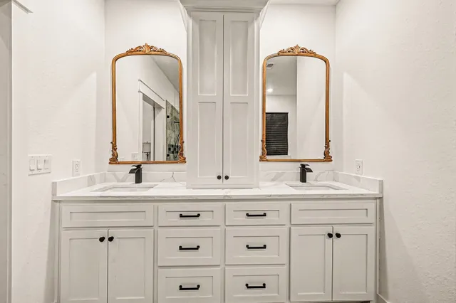 a bathroom with a double vanity sink and mirror