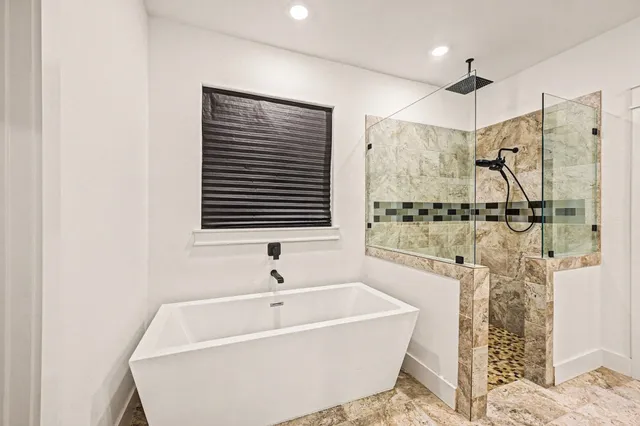 a bathroom with a bathtub and shower