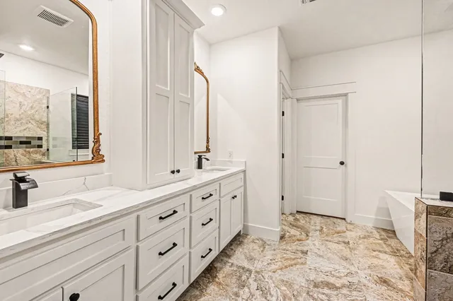 a bathroom with double sink and a mirror