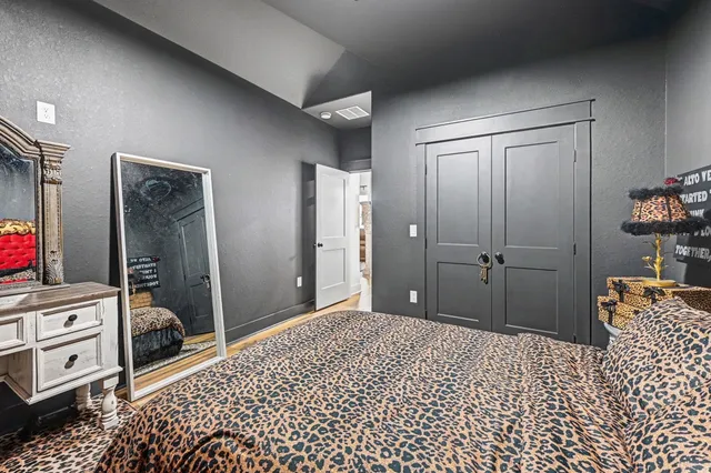 a bedroom with a bed and a walk in closet