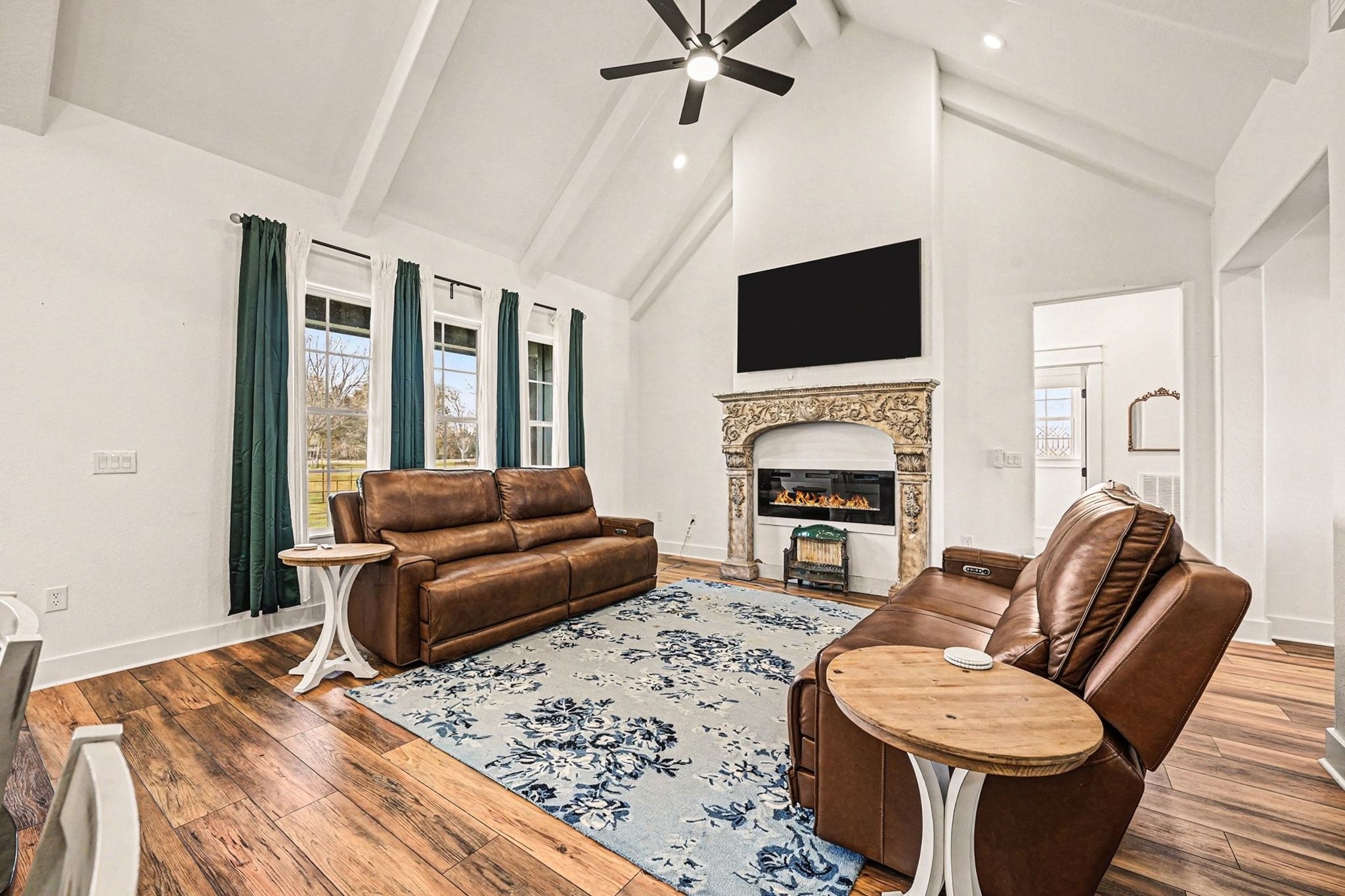 444 Mill Road Angleton, TX 77515 - Photo 5 of 31 a living room with furniture a flat screen tv and a fireplace