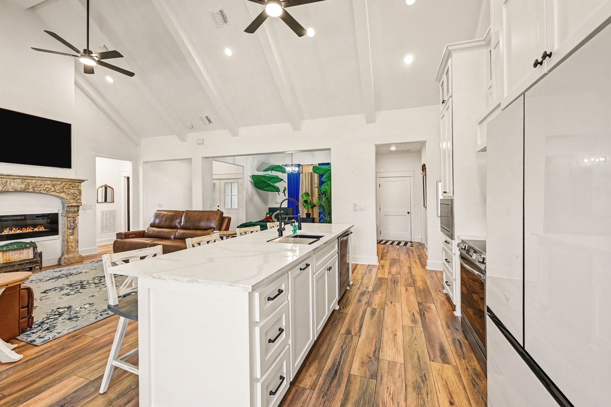444 Mill Road Angleton, TX 77515 - Photo 8 of 31 a kitchen with kitchen island a sink counter top space appliances and a ceiling fan
