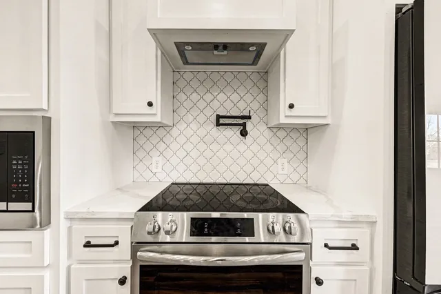 a stove top oven sitting inside of a kitchen