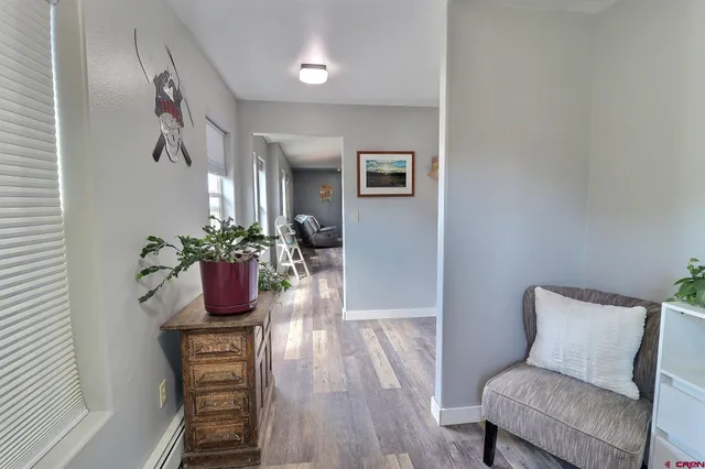 a dining room with furniture and wooden floor
