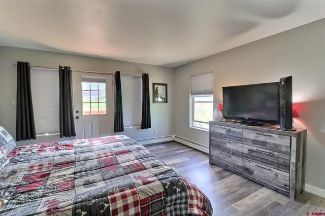 a bedroom with a bed and a flat screen tv