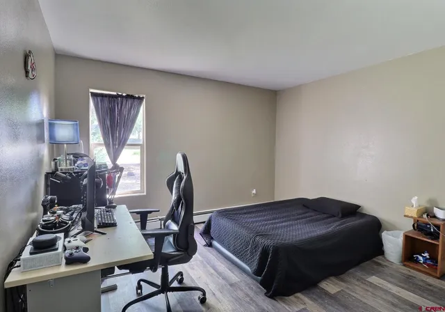 a view of a workspace with furniture and gym equipment