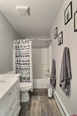 a bathroom with a sink a toilet and a shower