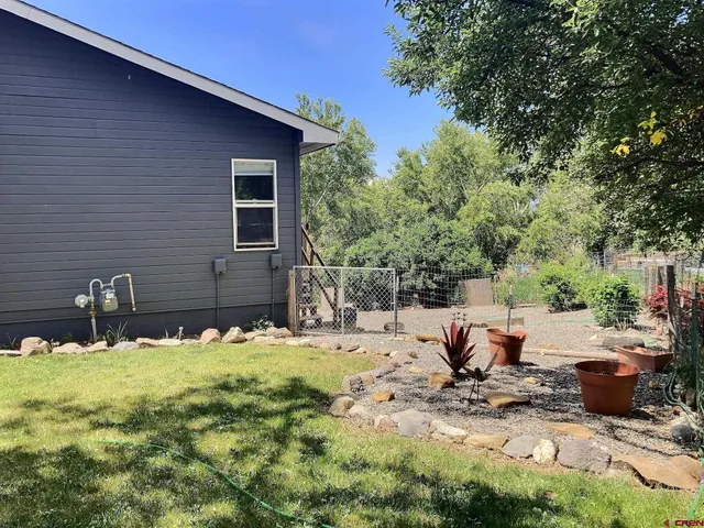 a view of a backyard with sitting area