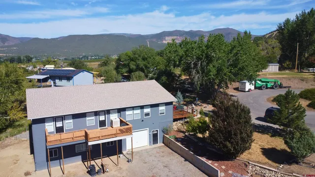 an aerial view of a house with a yard