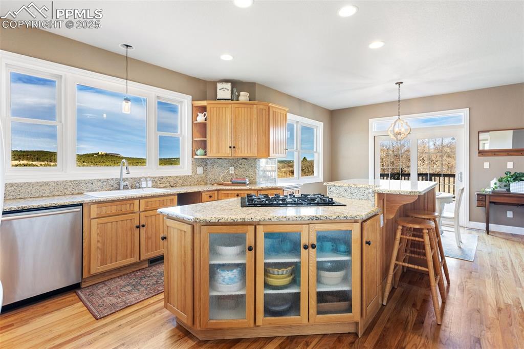931 Forest View Road Monument, CO 80132 - Photo 12 of 50 a kitchen with a stove a sink and a refrigerator