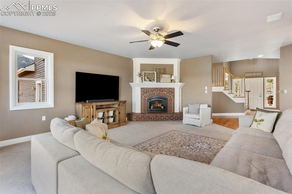 931 Forest View Road Monument, CO 80132 - Photo 17 of 50 a living room with furniture flat screen tv and a fireplace