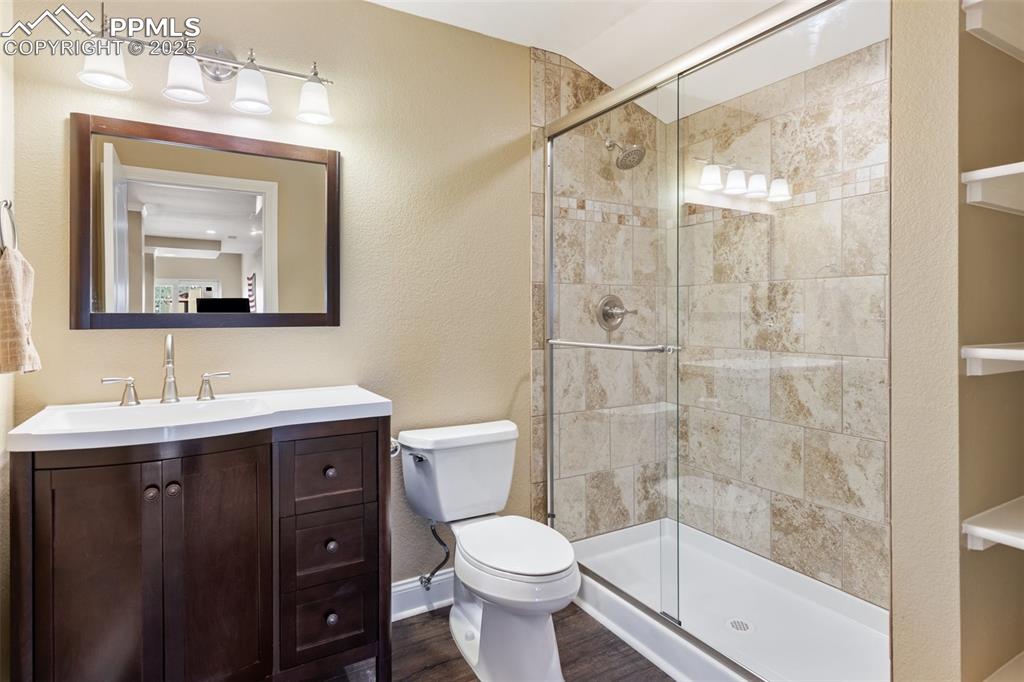 931 Forest View Road Monument, CO 80132 - Photo 21 of 50 a bathroom with a toilet sink vanity and shower