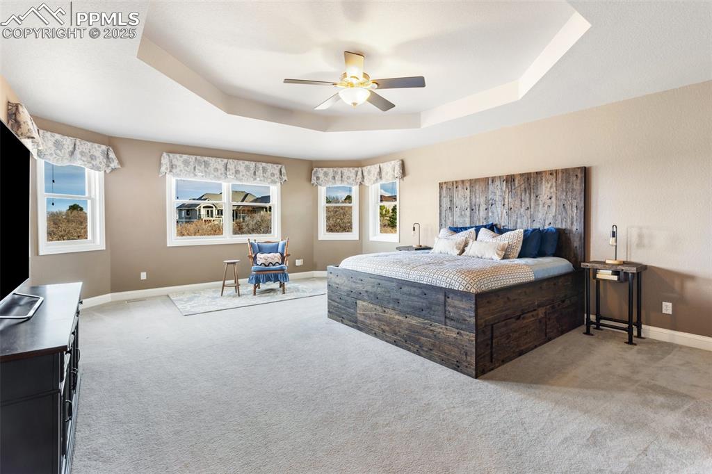 931 Forest View Road Monument, CO 80132 - Photo 23 of 50 a bedroom with a bed and a chandelier