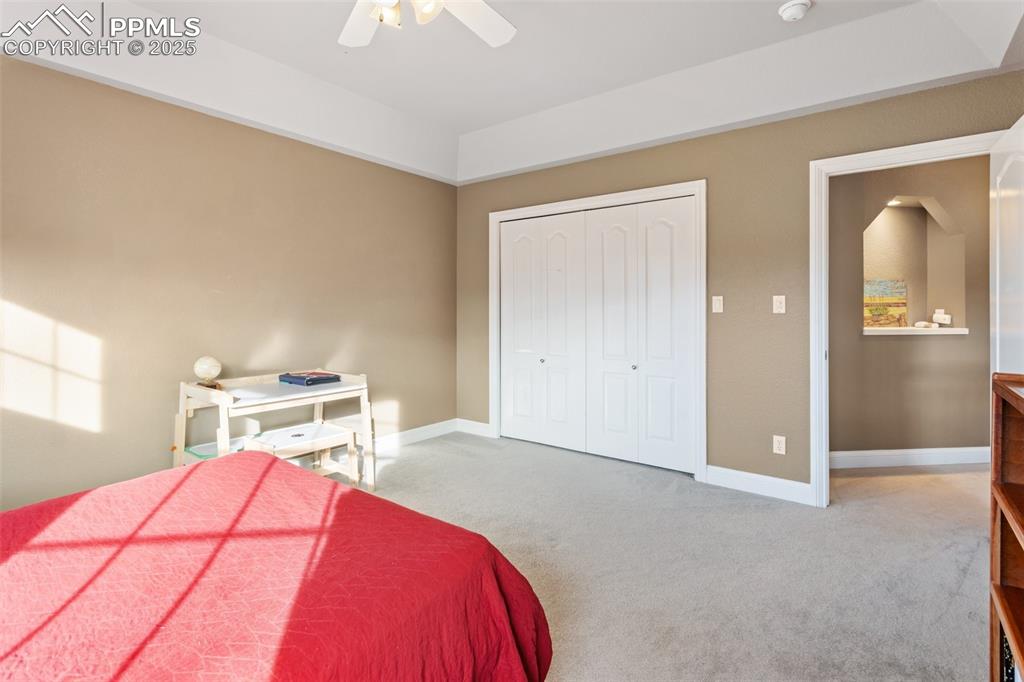 931 Forest View Road Monument, CO 80132 - Photo 28 of 50 a bedroom with a bed and a chandelier