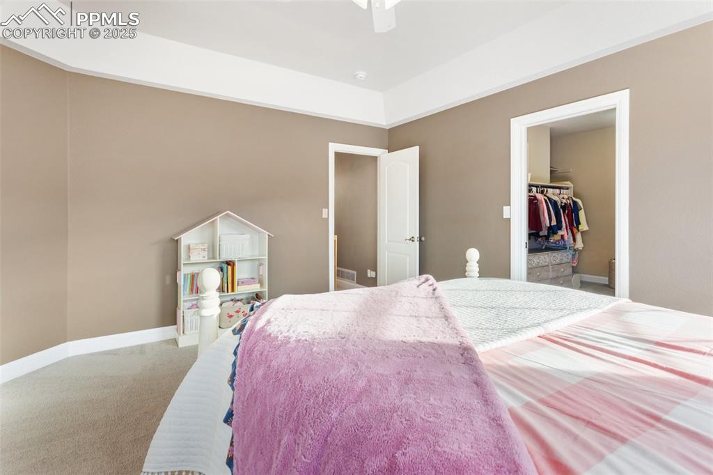 931 Forest View Road Monument, CO 80132 - Photo 30 of 50 a bedroom with a bed and a mirror