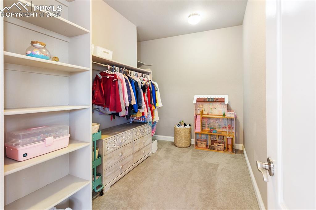 931 Forest View Road Monument, CO 80132 - Photo 31 of 50 a view of walk in closet with clothes and shoes