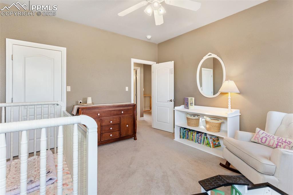 931 Forest View Road Monument, CO 80132 - Photo 34 of 50 a bedroom with a bed and a chandelier