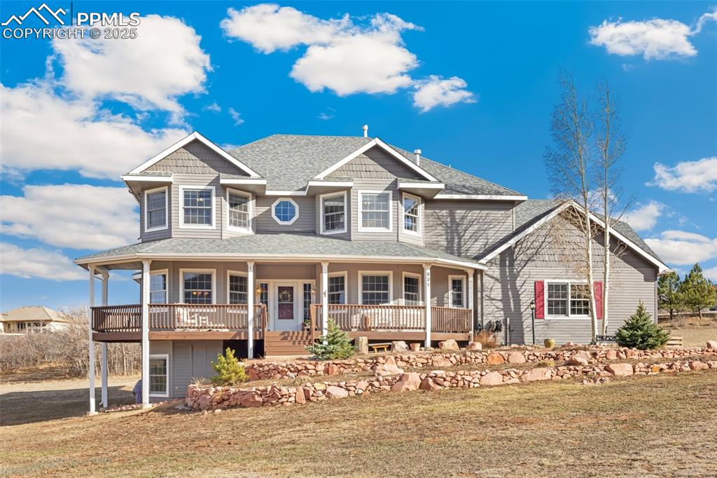 931 Forest View Road Monument, CO 80132 - Photo 4 of 50 a front view of a house with a yard