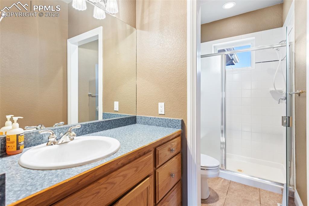 931 Forest View Road Monument, CO 80132 - Photo 42 of 50 a bathroom with a granite countertop sink and a mirror