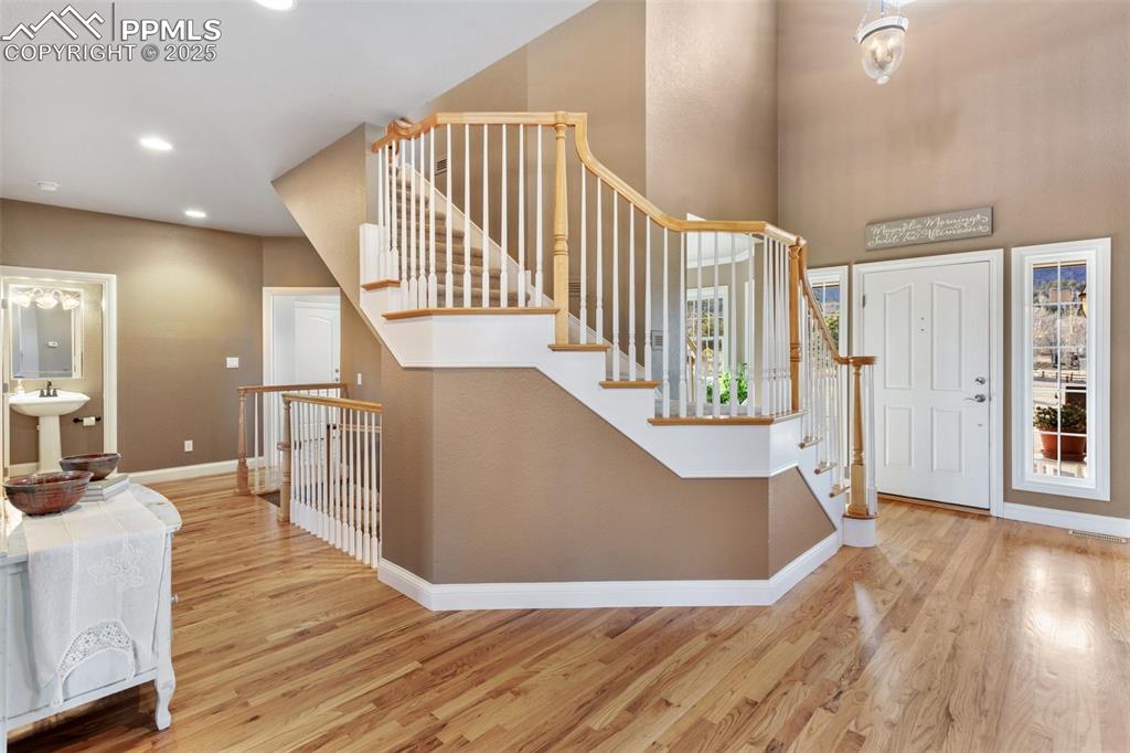 931 Forest View Road Monument, CO 80132 - Photo 9 of 50 a view of a hallway with wooden floor and staircase