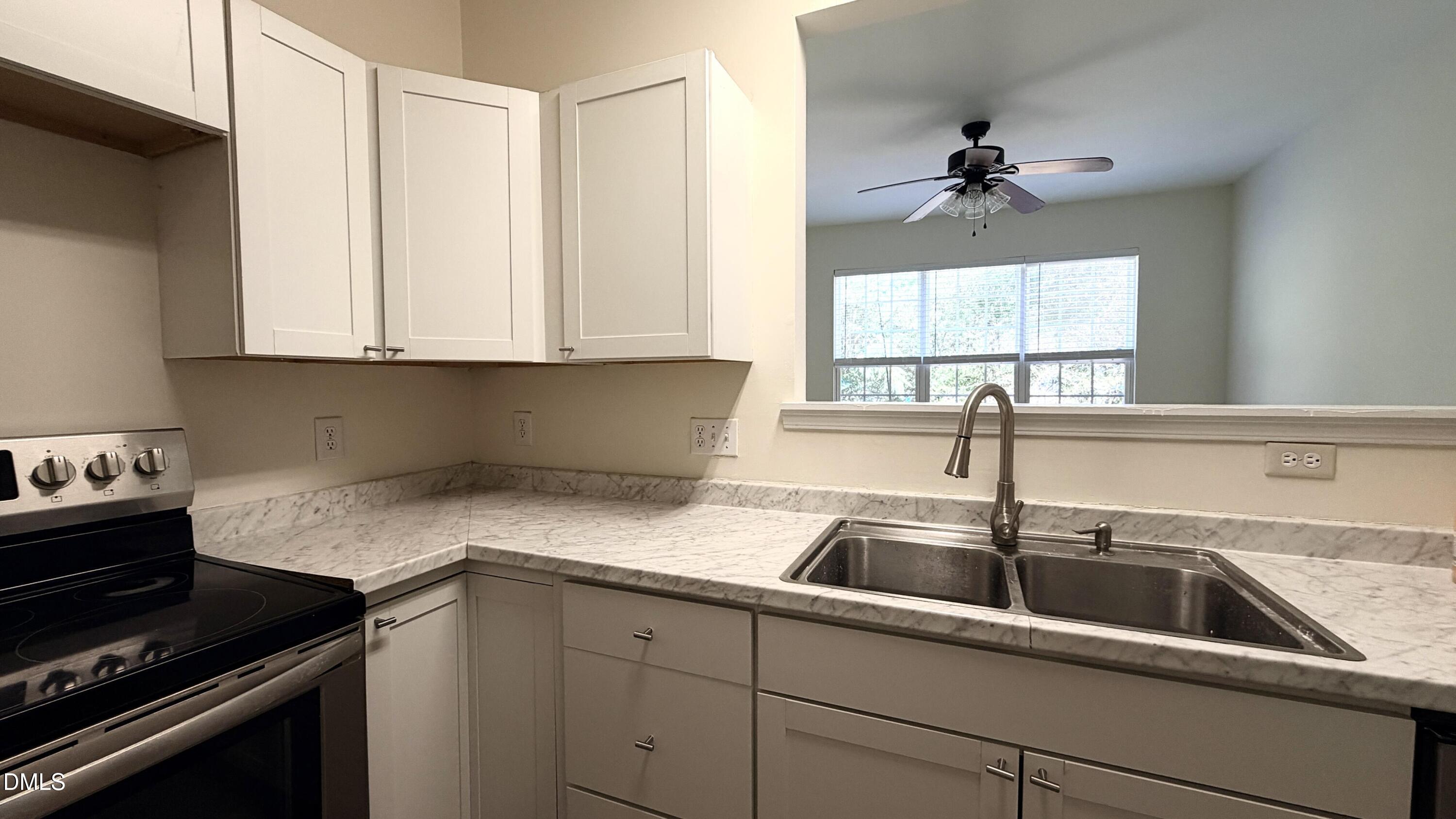 4123 Standing Rock Way Raleigh, NC 27604 - Photo 7 of 29 a kitchen with a sink and cabinets