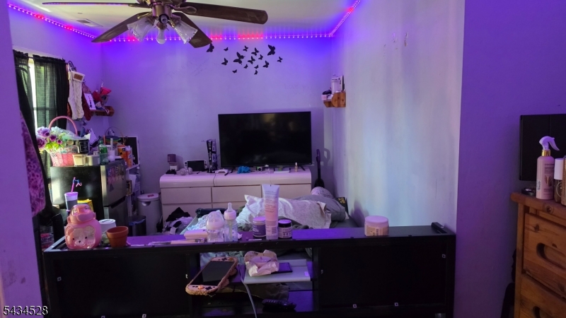 1115 West Camplain Road Manville, NJ 08835 - Photo 12 of 18 a room with wooden floor and a flat screen tv