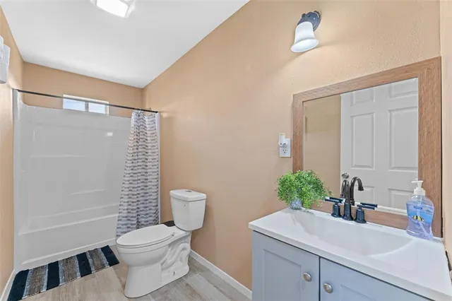 a dining room with furniture and a wooden floor