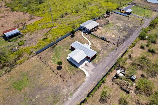 an aerial view of house with a yard